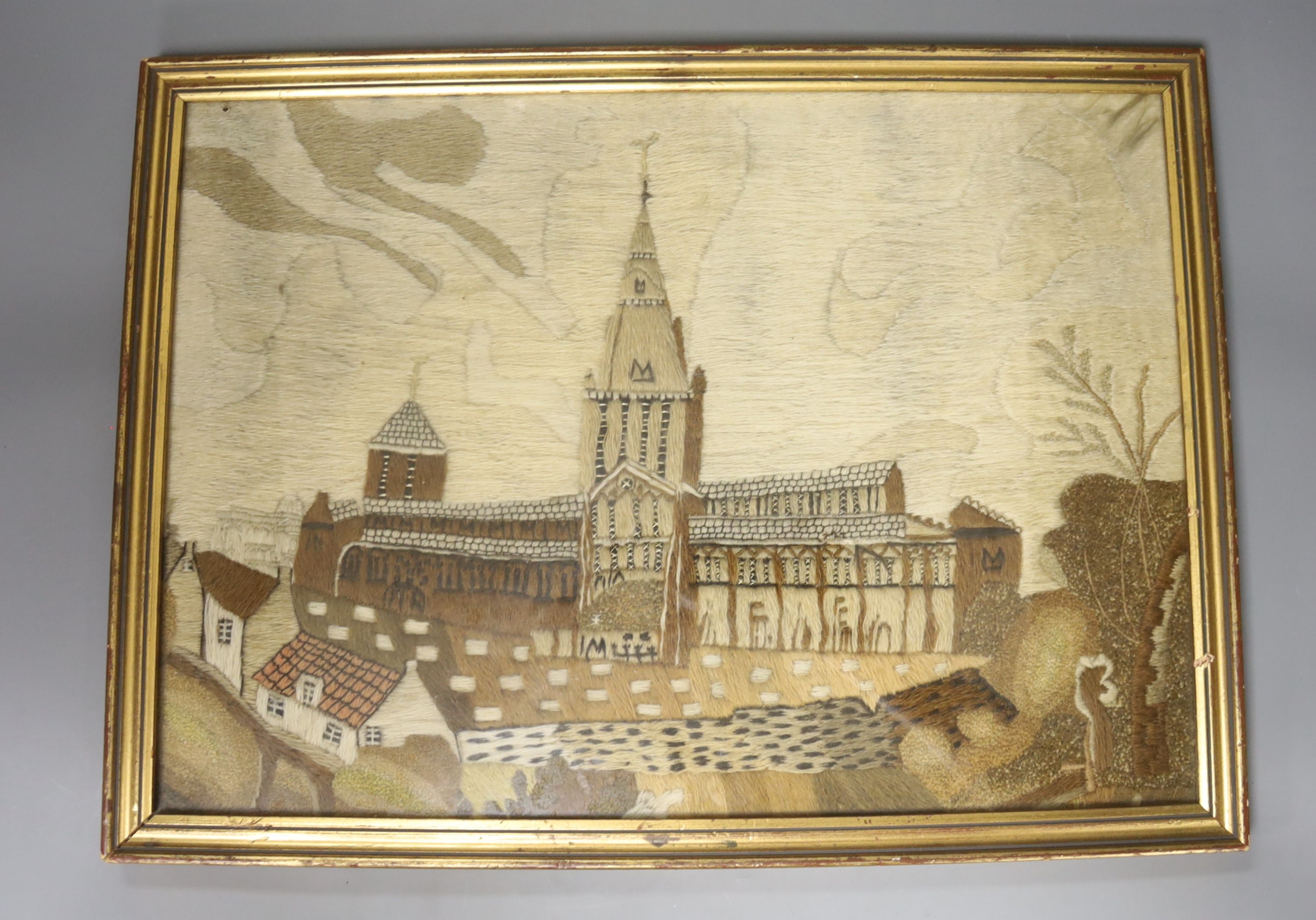 An unusual framed 19th century woolwork of a cathedral, 31 x 44cm